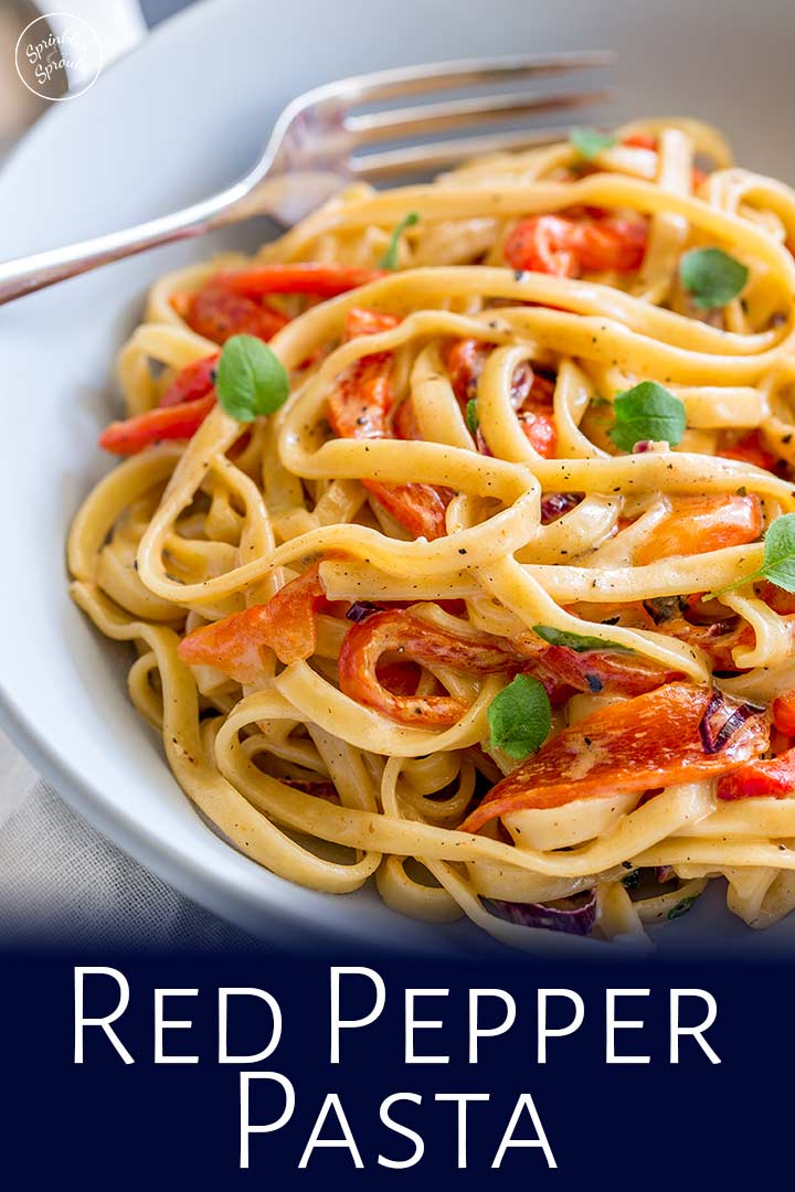 a pale blue bowl of roasted red pepper pasta with text at the bottom