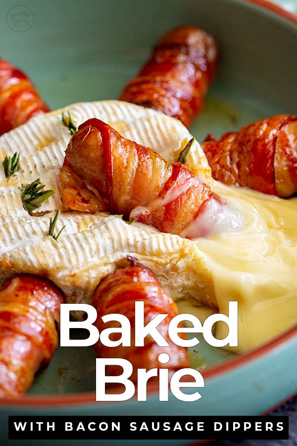 a bacon wrapped sausage sitting in baked brie with text at the bottom
