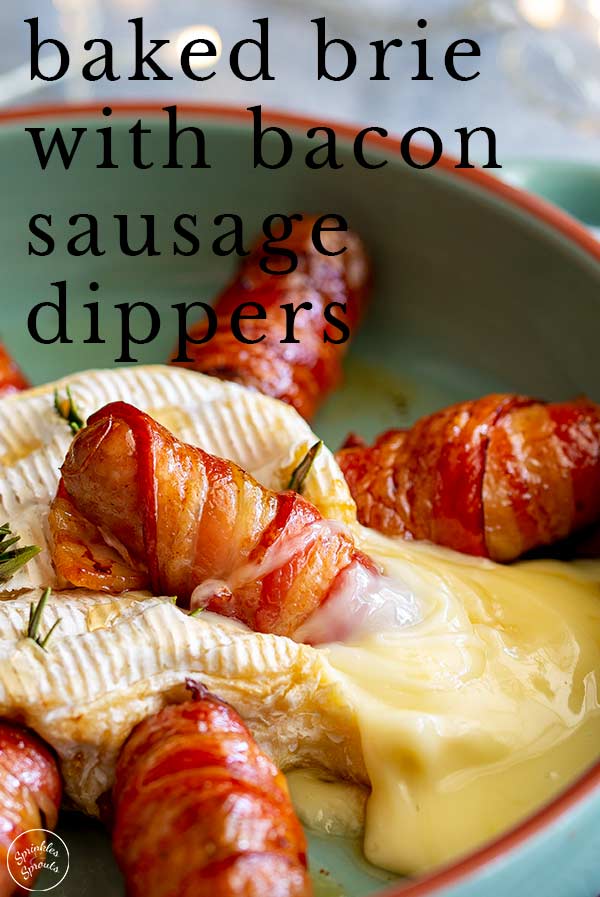 a bacon wrapped sausage sitting in baked brie with text at the top