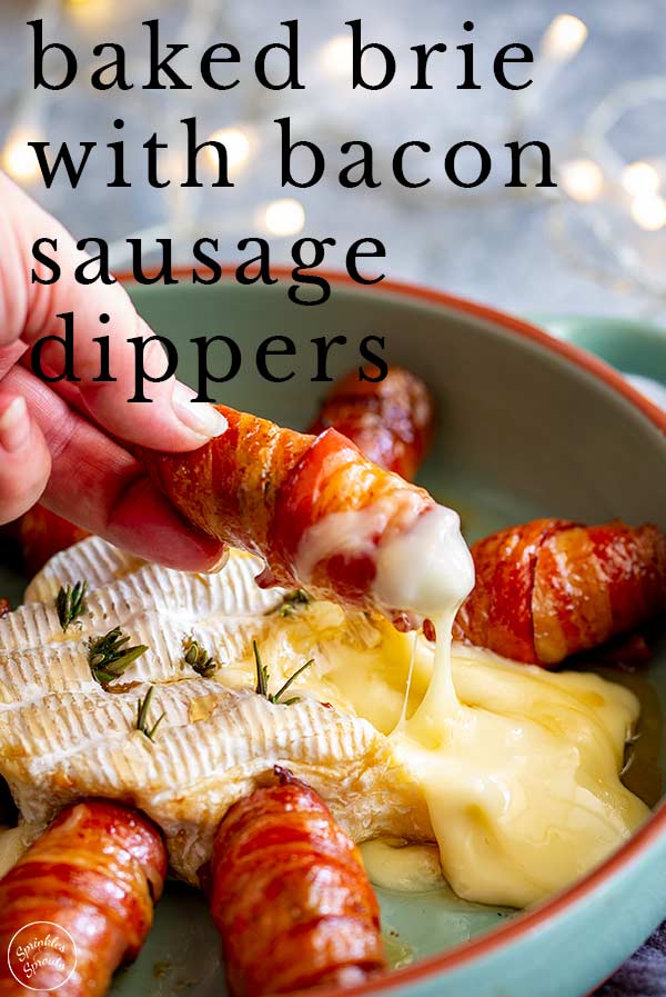 a hand dipping a bacon wrapped sausage into baked brie with text at the top