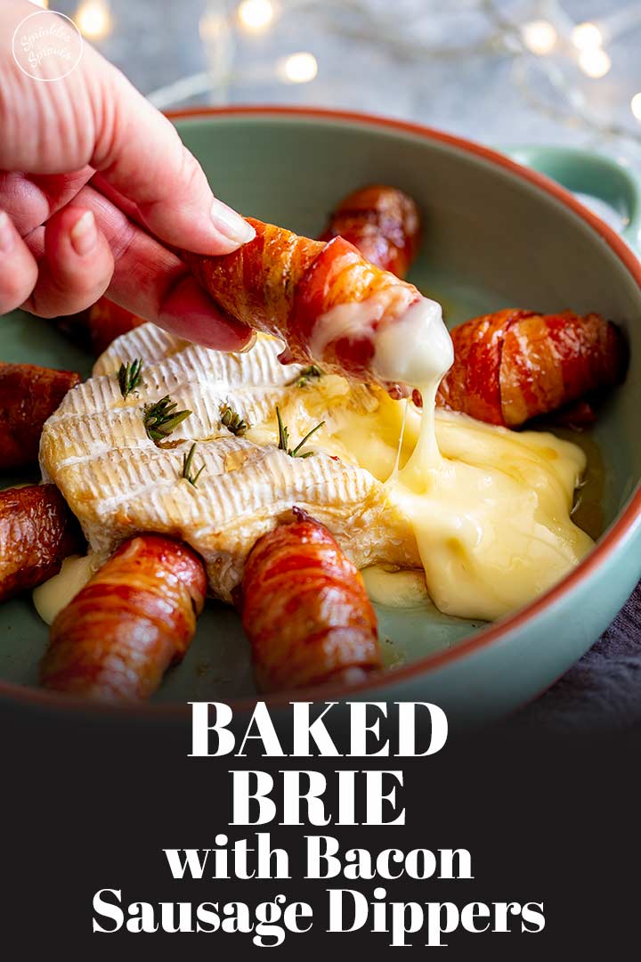 a hand dipping a bacon wrapped sausage in molten brie with text at the bottom