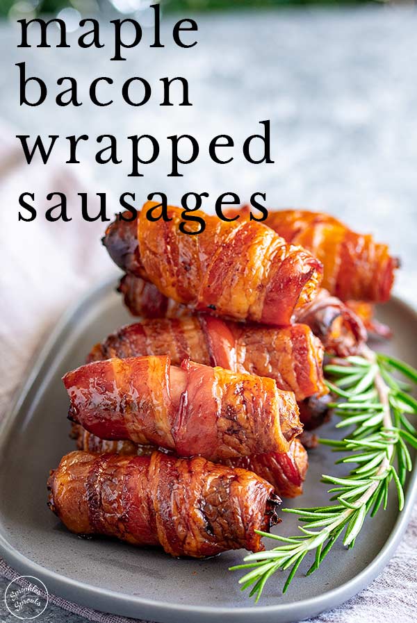 a grey oval plate piled with sausages wrapped in bacon with text at the top