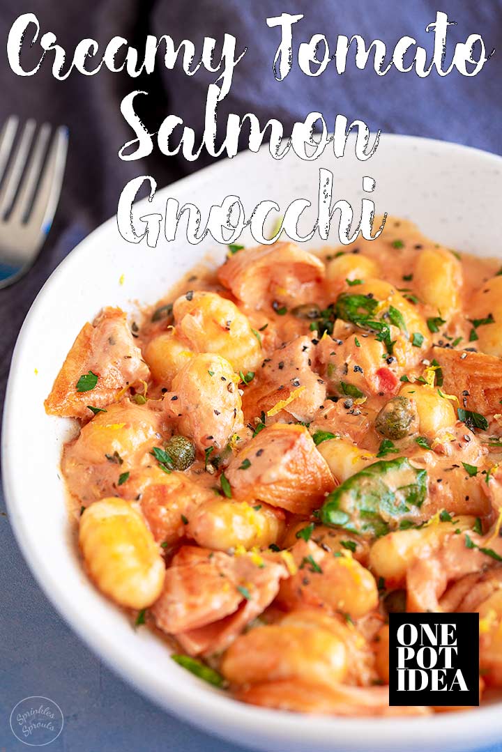 white bowl of creamy tomato salmon gnocchi with text at the top and bottom