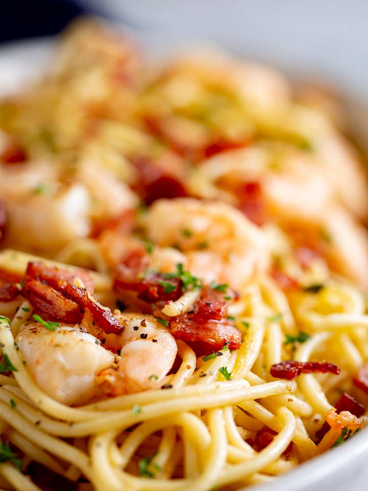 close up of the shrimp on top of spaghetti