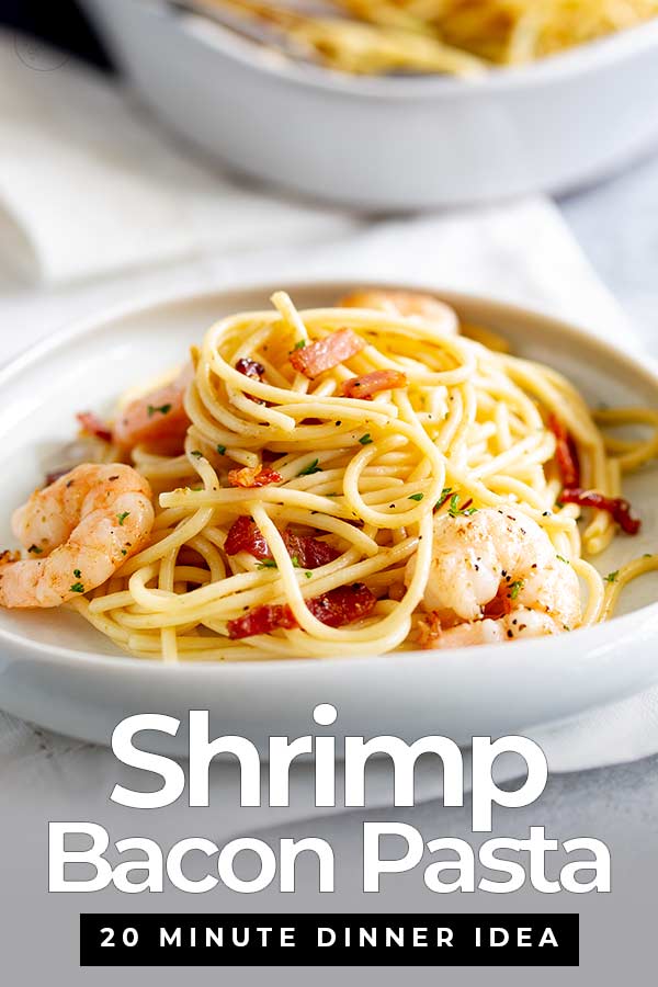 shrimp and bacon spaghetti on a white plate with text at the bottom