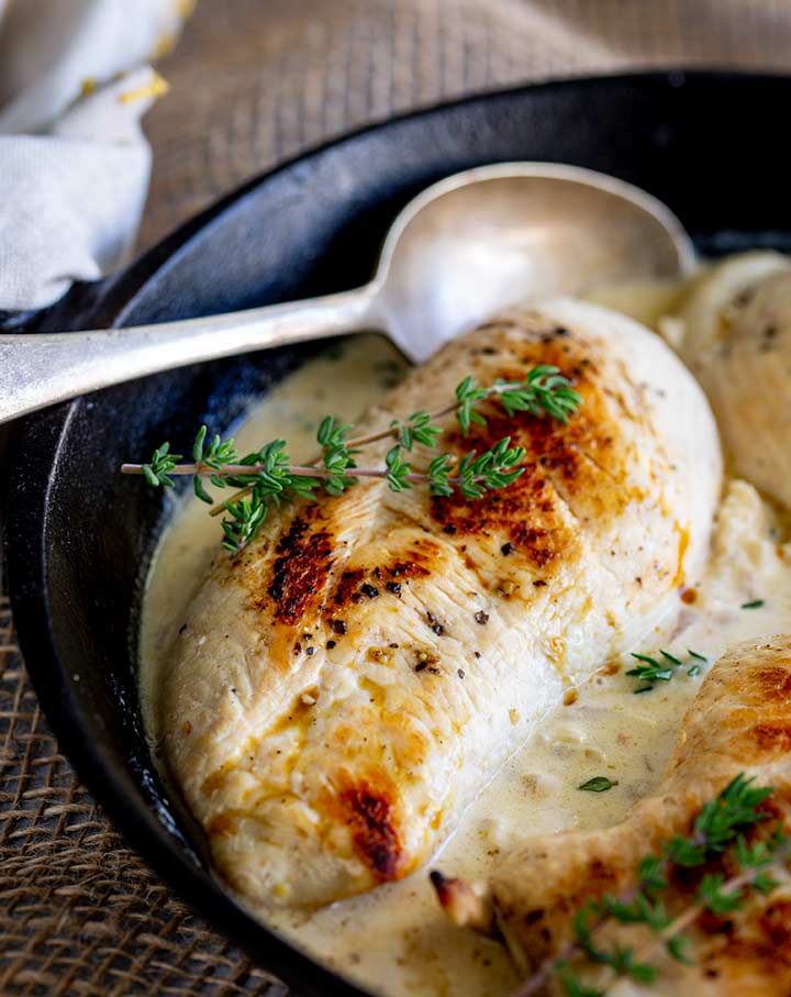 a creamy white wine sauce with cooked chicken breasts