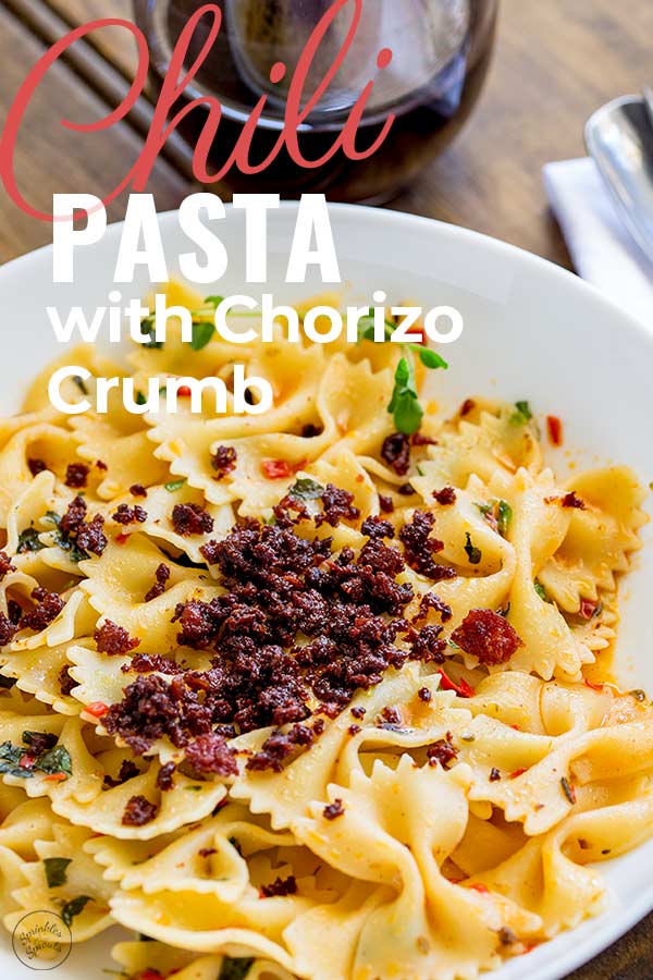crispy crunchy chorizo crumb on pasta with text at the top