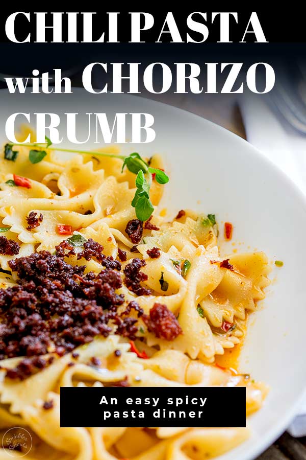 close up on the crispy chorizo on pasta with text at the top and bottom