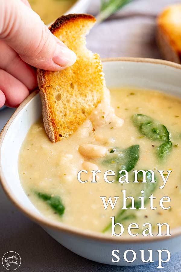 bread dipping into bean soup with text at the bottom