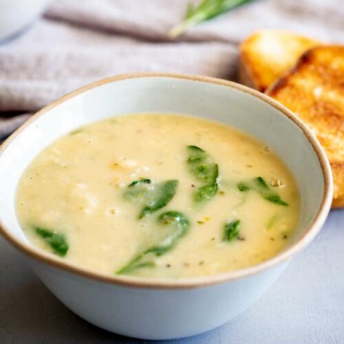 a rustic bowl of creamy soup with spinach