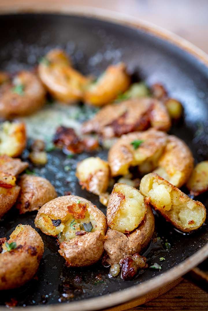close up on the crispy outside and fluffy inside of the fried potatoes