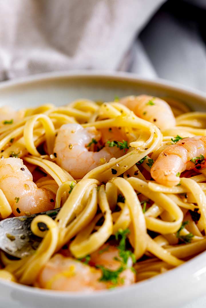 a high lipped plate of linguine with shrimp