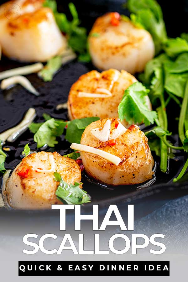 cast iron pan of seared Thai scallop with text at the bottom