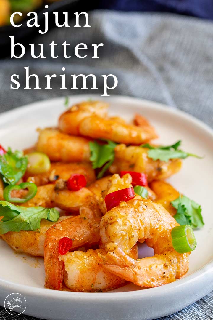 PIN IMAGE: cajun shrimp on a white plate with text in the top left