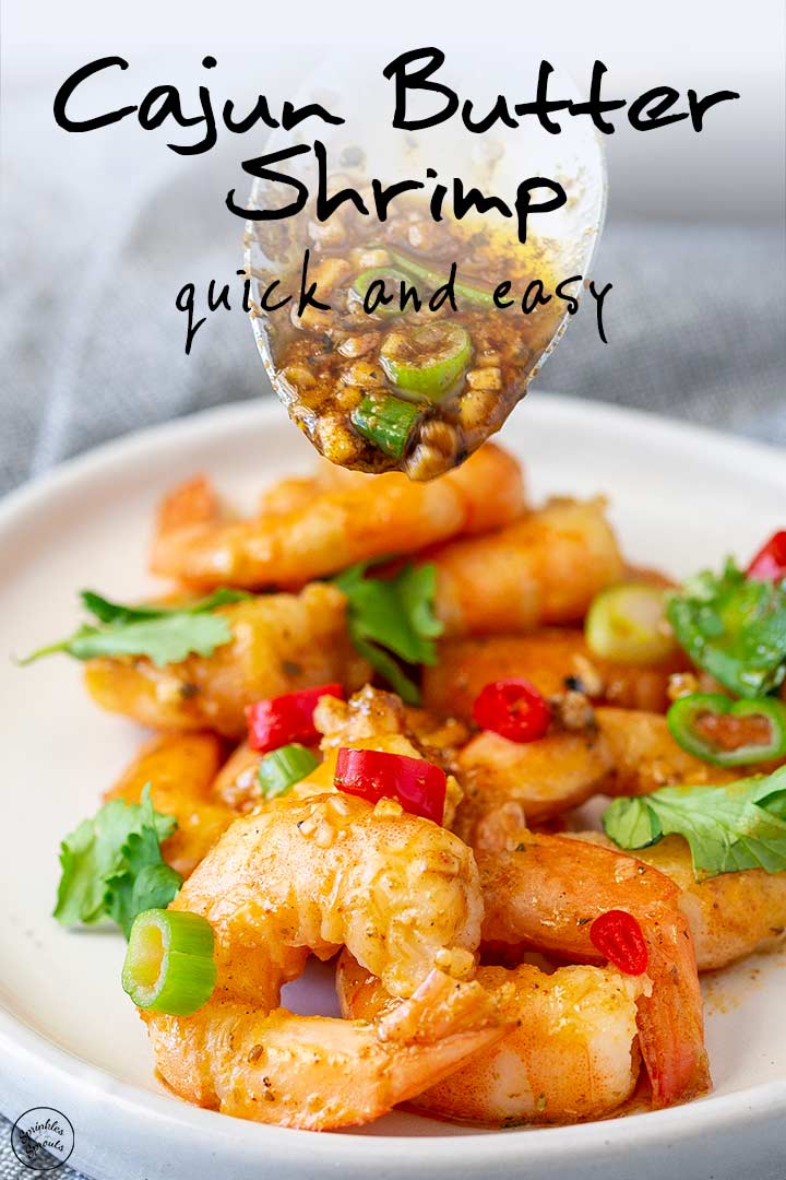 PIN MINAGE: a spoon drizzling cajun butter over shrimp with text at the top