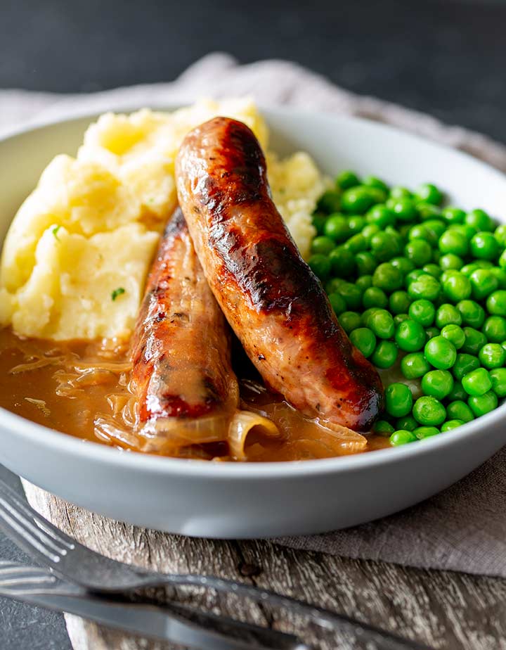 two sausages on a bed of mashed potato and gravy