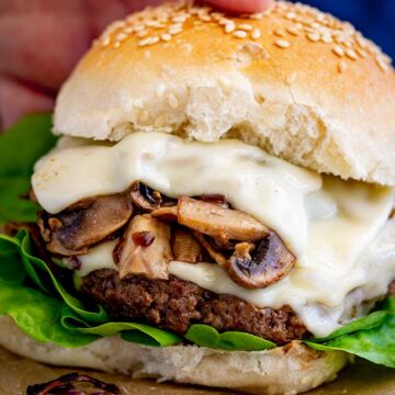 close up of the mushrooms and cheese on a burger