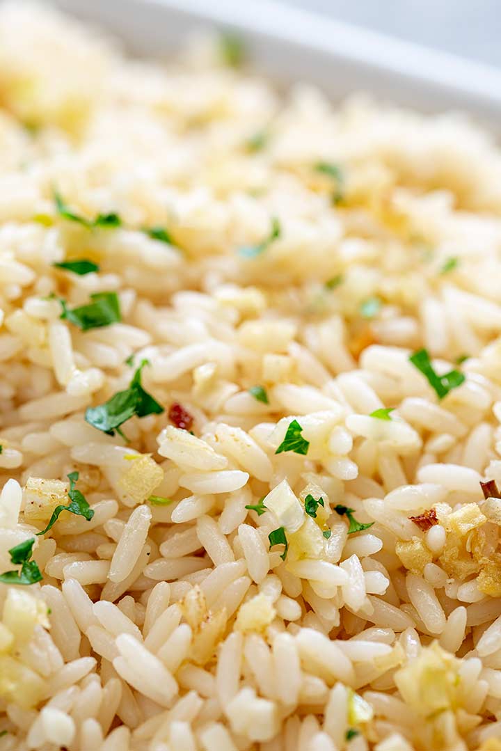 close up of the rice grains and minced garlic