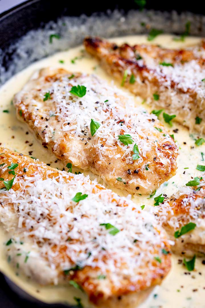 4 parmesan covered chicken breasts in a creamy sauce