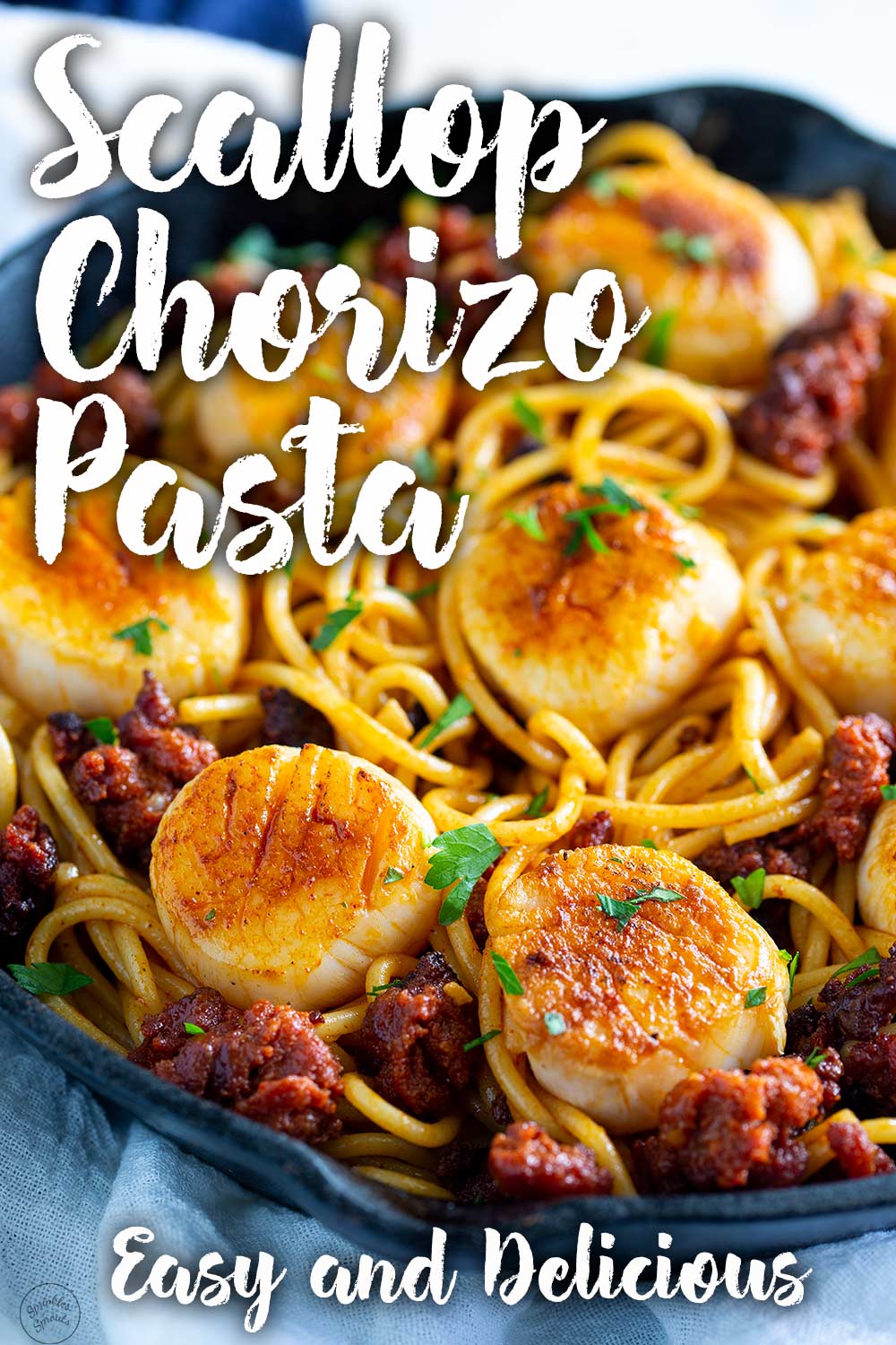 a picture of the scallop chorizo pasta, with text overlay for using on pinterest