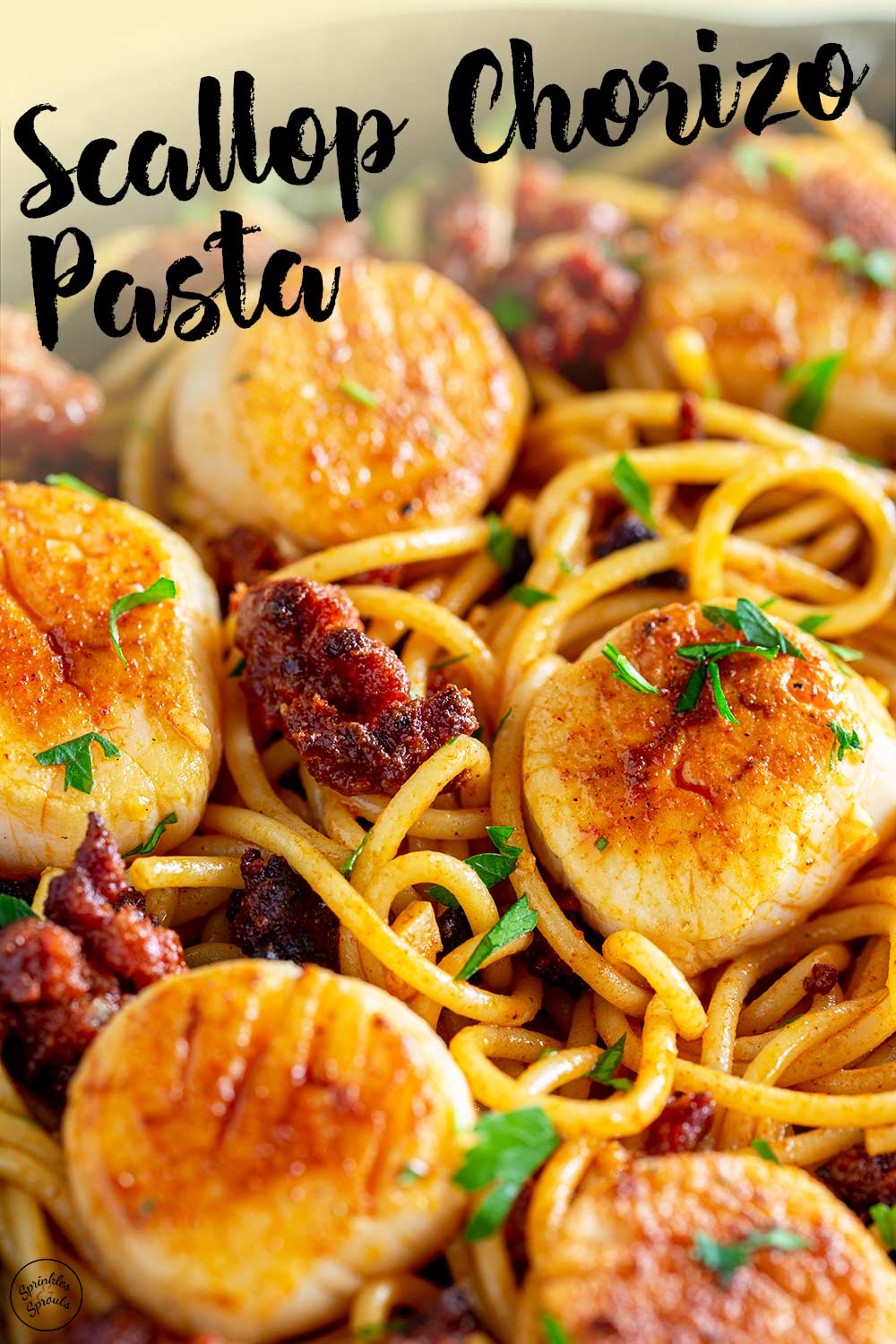 a picture of the scallop chorizo pasta, with text overlay for using on pinterest