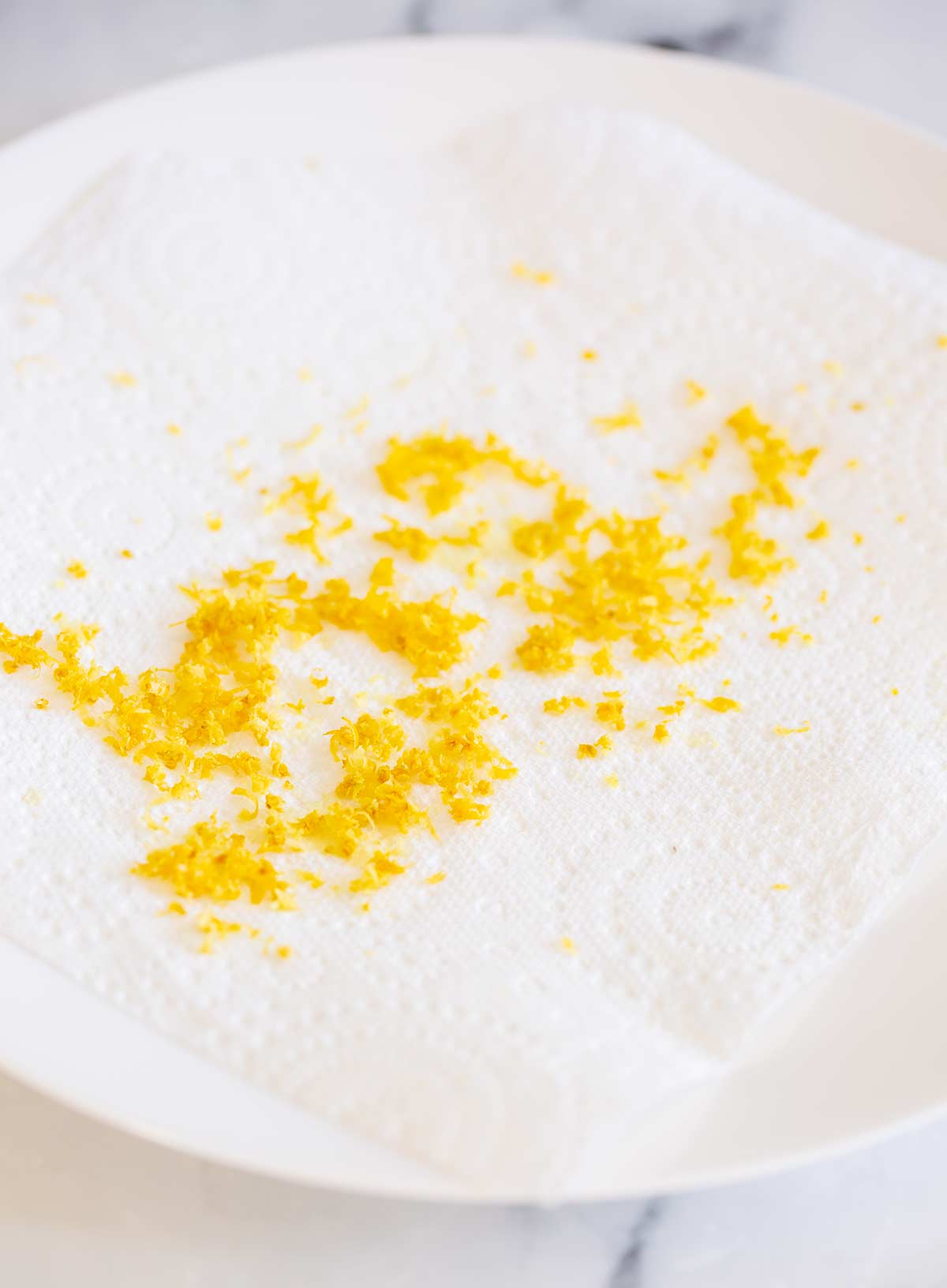 fresh lemon zest on a plate with kitchen paper