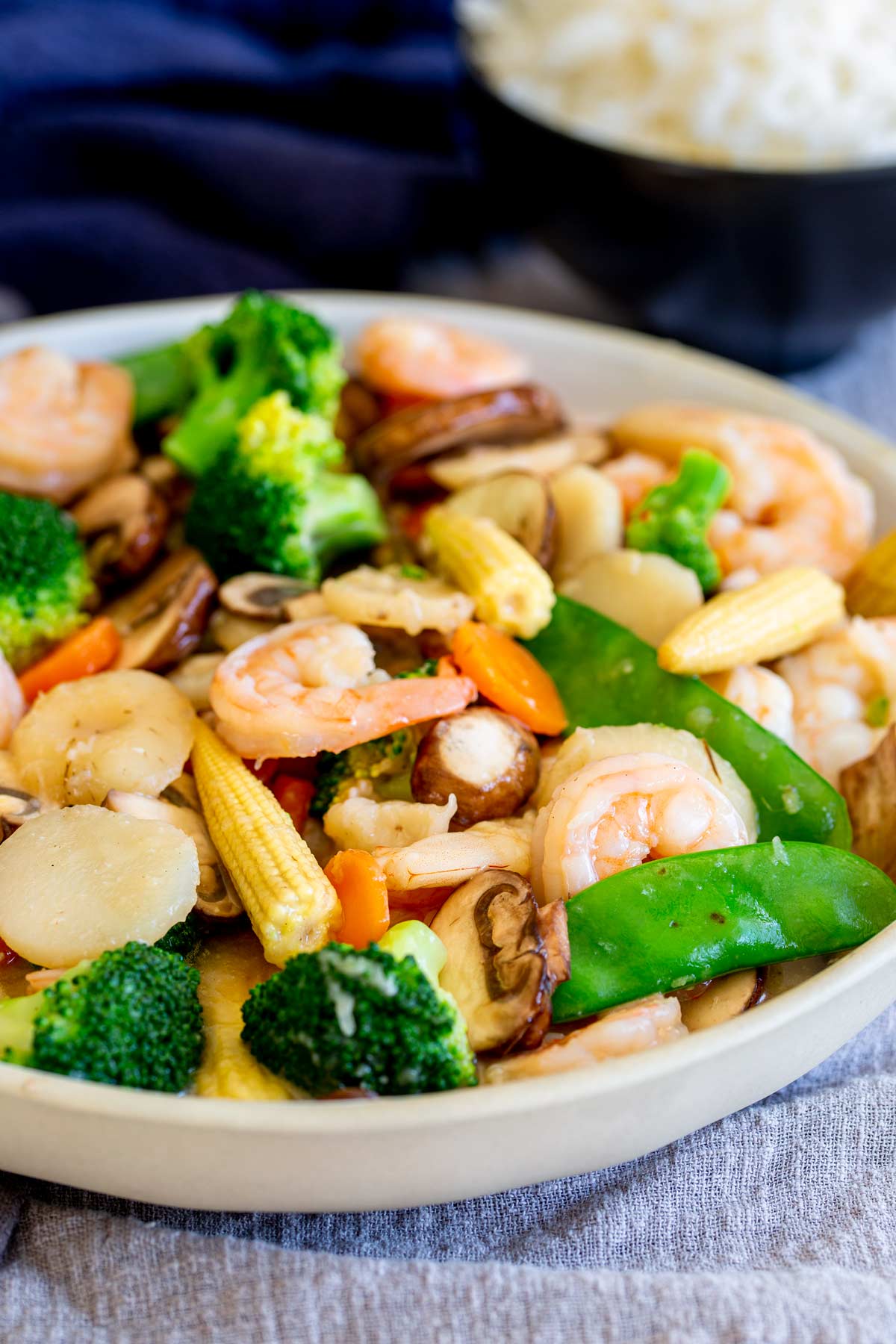 a large serving bowl of Chinese vegetables and shrimp