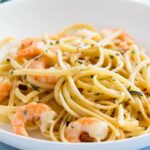 linguine and shrimp in a bowl with rosemary oil