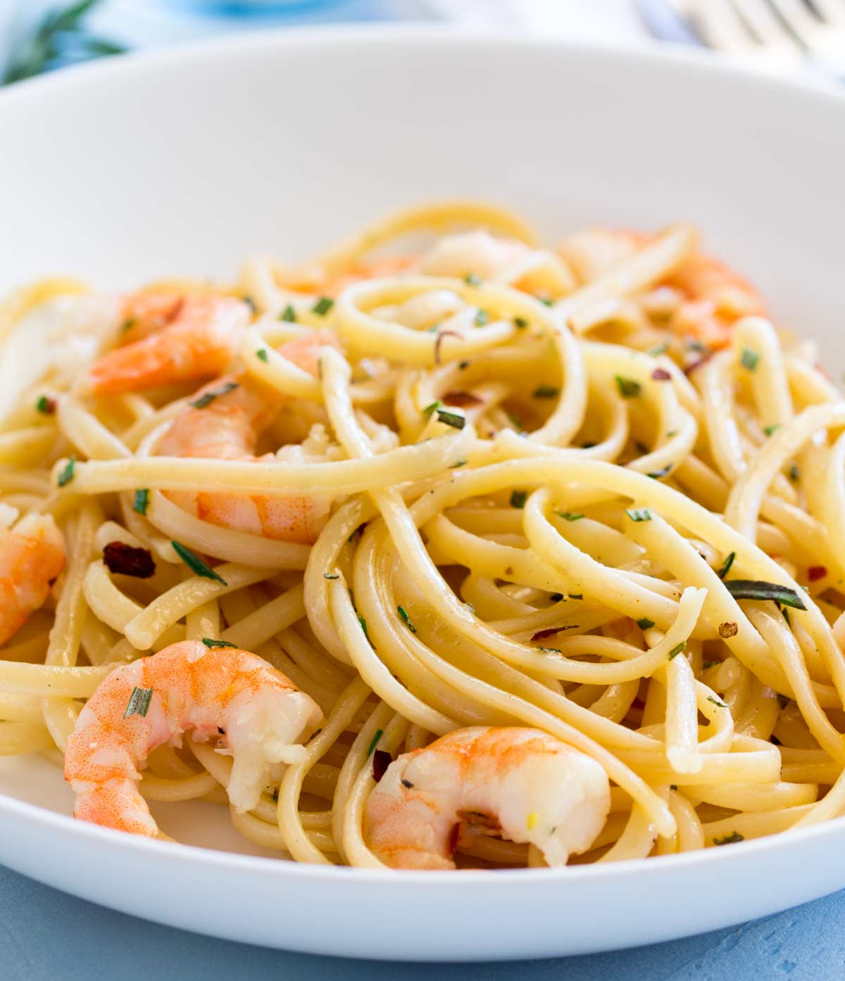 linguine and shrimp in a bowl with rosemary oil