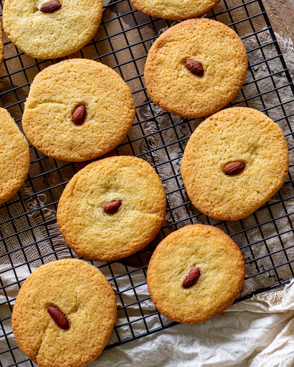 Almond cookies on a black cooling rack