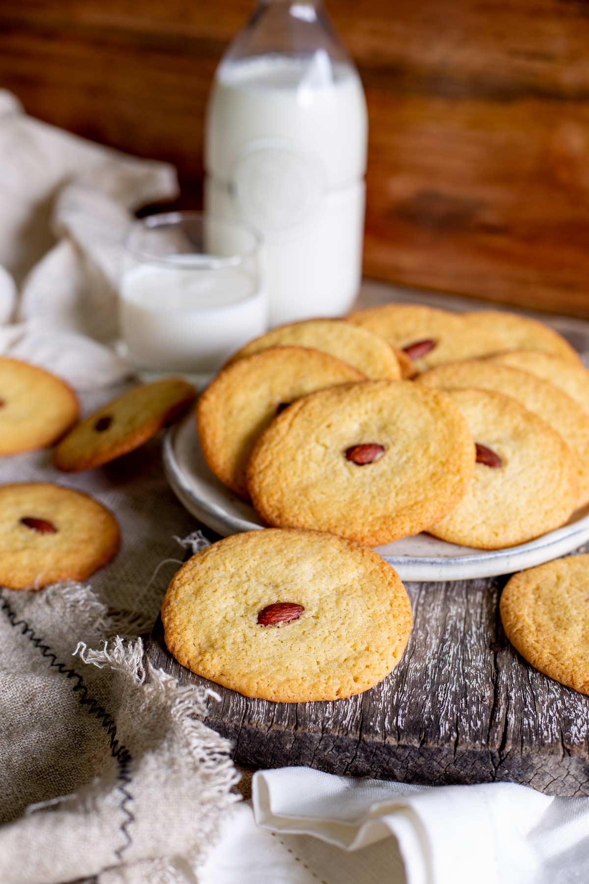 Rustic photo of flat cookies on a plate and wooden board