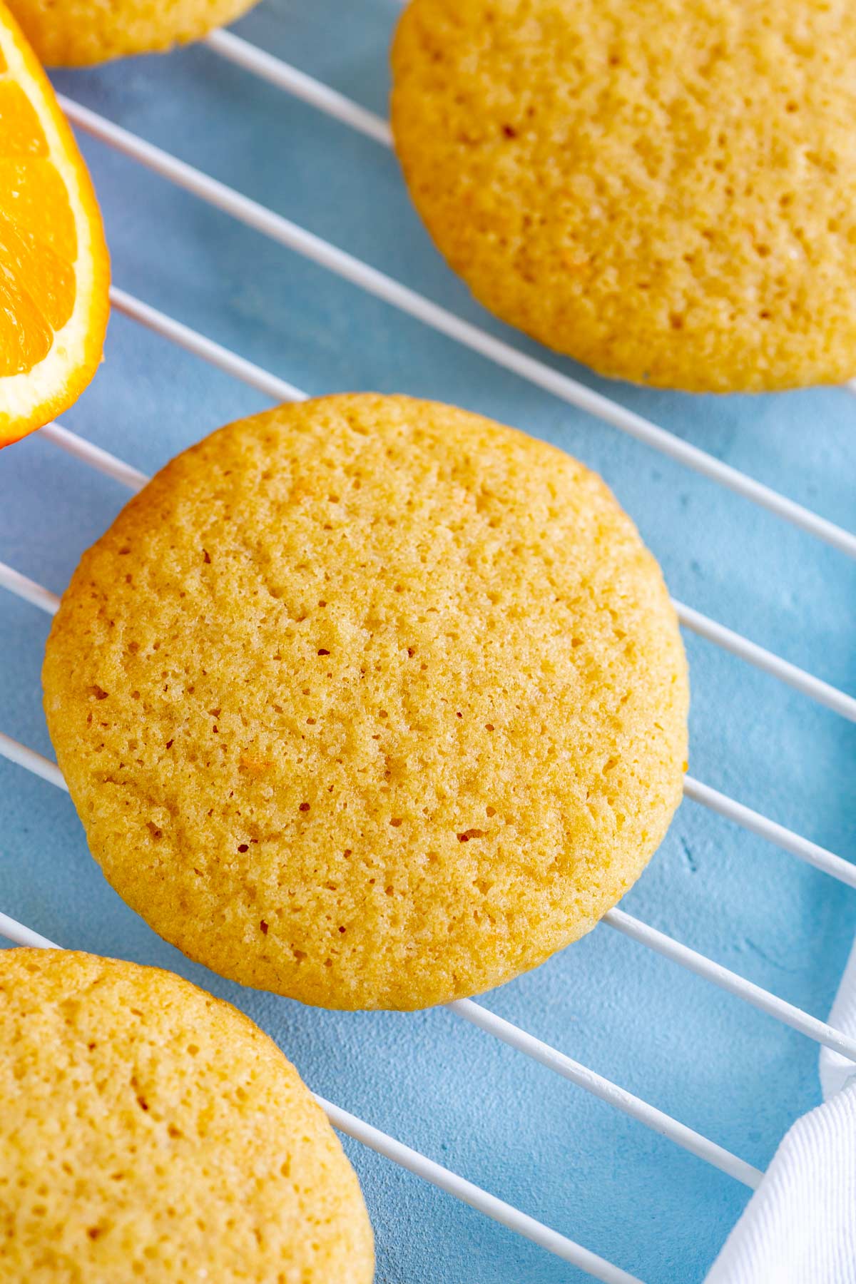 overhead view of orange cookies on a cooling rack