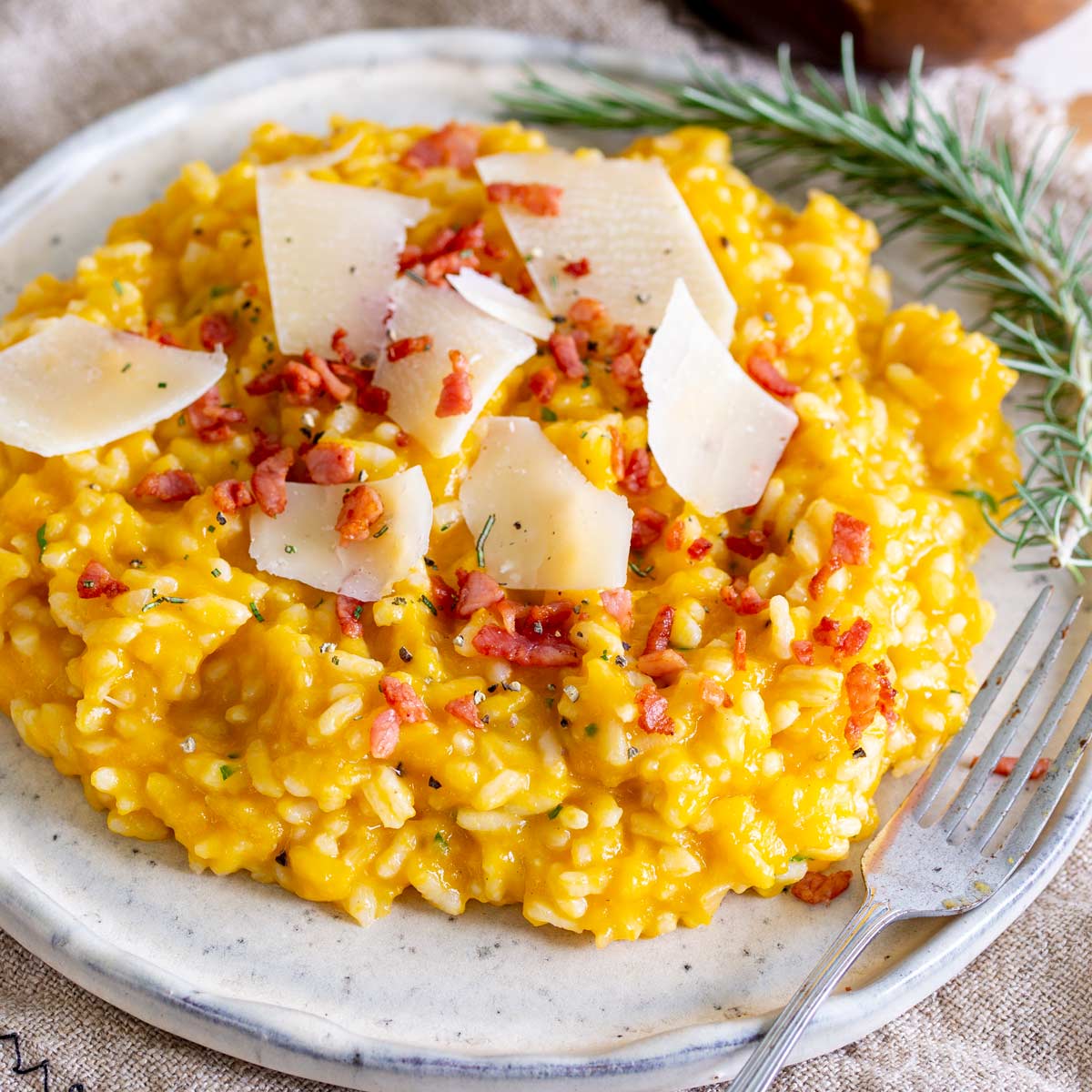 close up on the crispy bacon on top of a pumpkin risotto