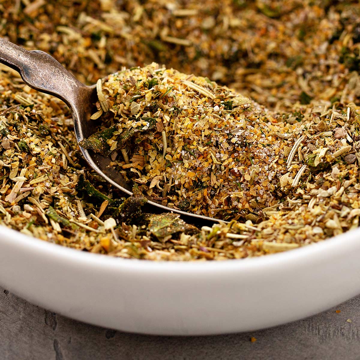 close up on a spoon in a bowl of herbs and spices