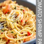 pinterest image: tomato shrimp pasta in a bowl with text overlaid
