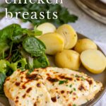 pin image: cheesy chicken breast on a plate with salad and potatoes with text overlaid