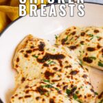 pin image: cheesy chicken breasts in a pan with text overlaid