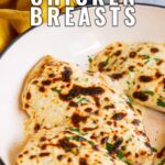 pin image: cheesy chicken breasts in a pan with text overlaid