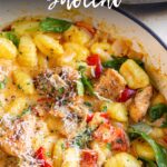 pin image: Cajun chicken gnocchi in a cast iron pan with text overlaid