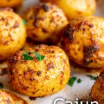 Pin Image: Roasted cajun potatoes in a rustic dish with text overlaid