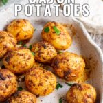 Pin Image: Roasted cajun potatoes in a rustic dish with text overlaid
