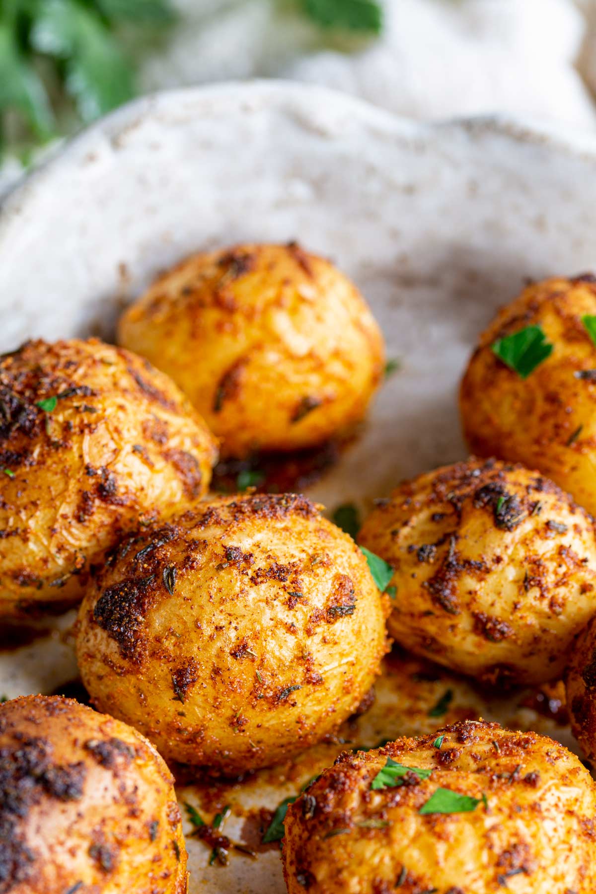 A Rustic dish of cooked potatoes coated in a red spice blend