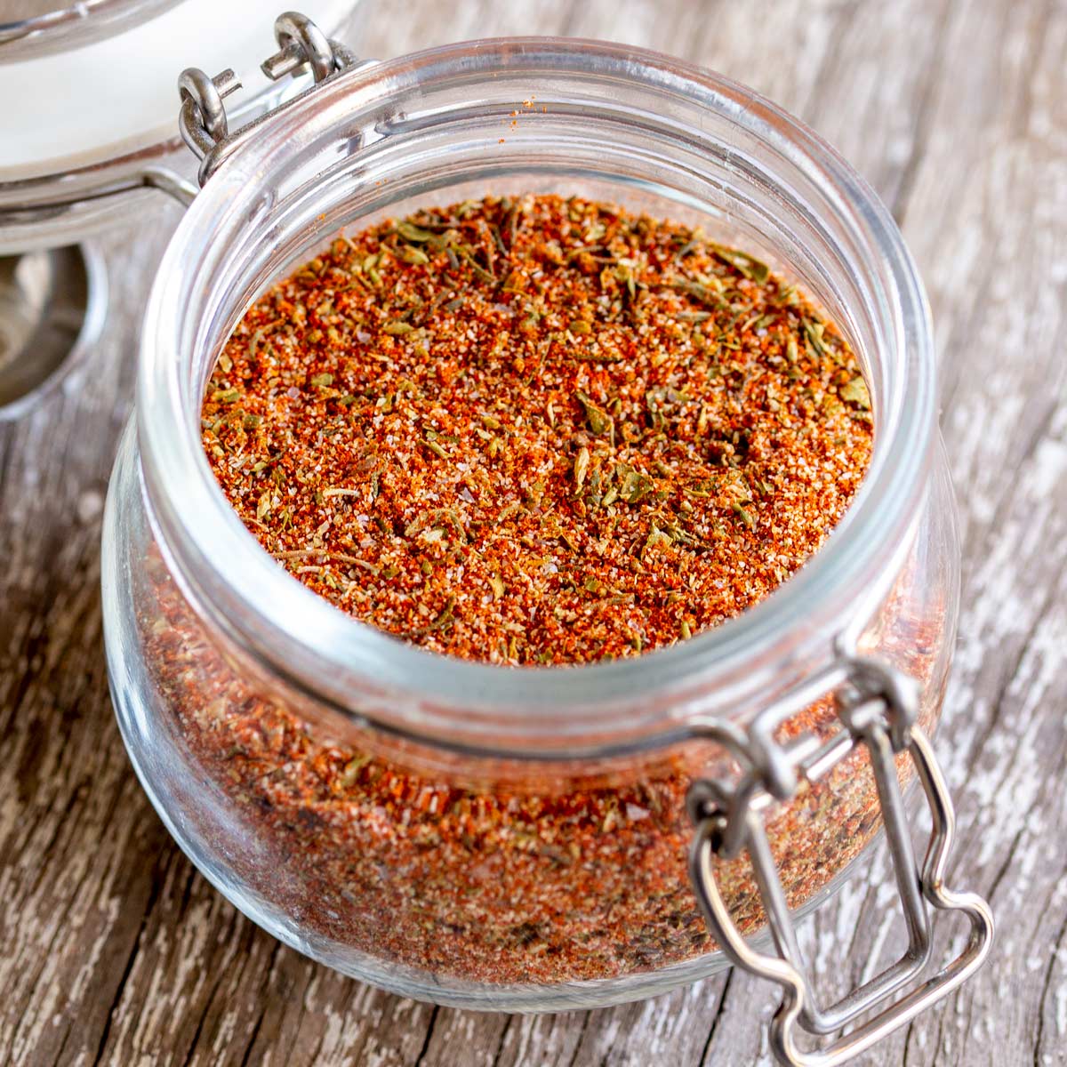 close up on the top of a glass jar filled with a homemade seasoning blend