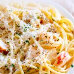 pin image: a plate of creamy lobster pasta with text overlaid
