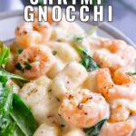 Pinterest image: Creamy shrimp gnocchi on a grey plate with text overlaid