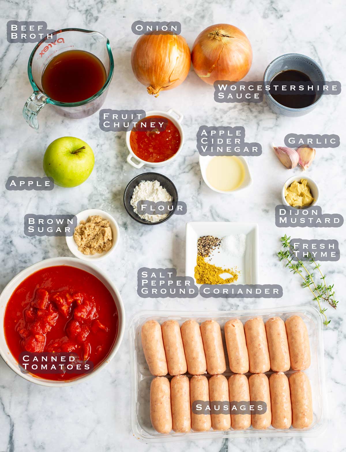 a marble table with the ingredients for devilled sausages laid out on it