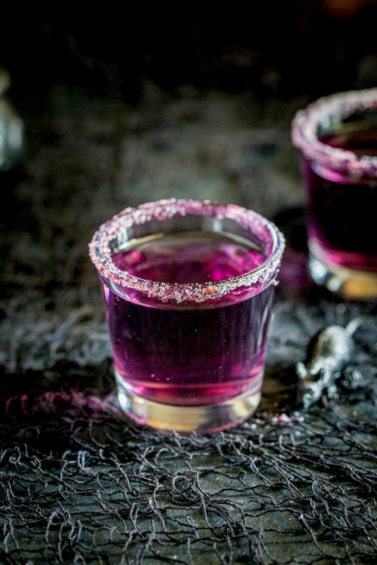 Over head shot, clearly showing the purple sugar rim on the shot glass.