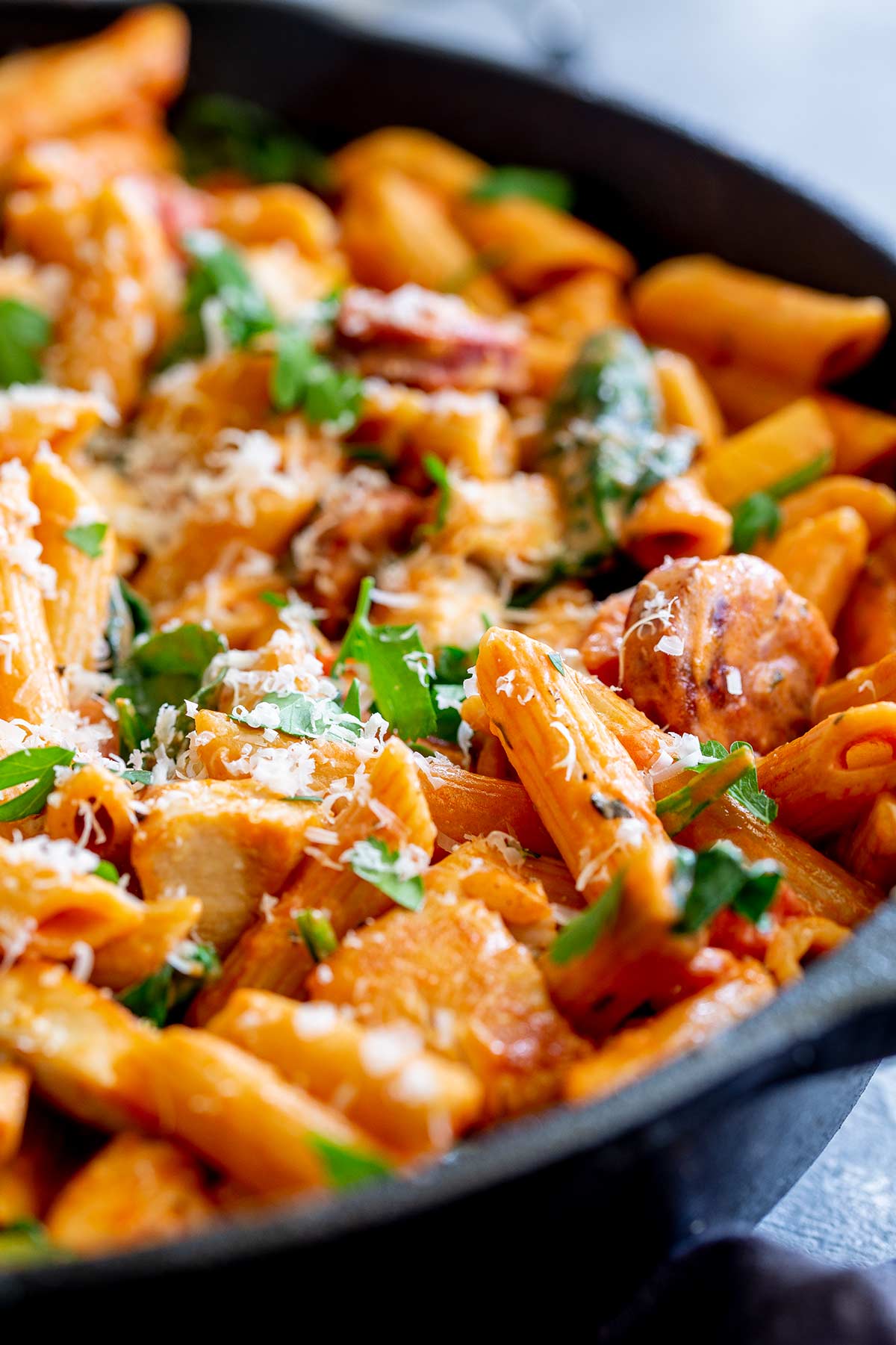 close up on a piece of penne in a creamy tomato sauce