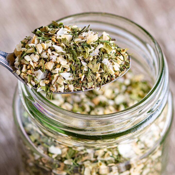 super close up photo of a herb seasoning on a silver spoon