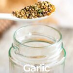 pin image: a spoon of garlic pepper seasoning with text overlaid